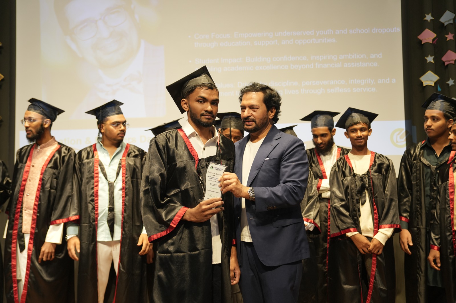 A graduate receiving an award during a graduation ceremony